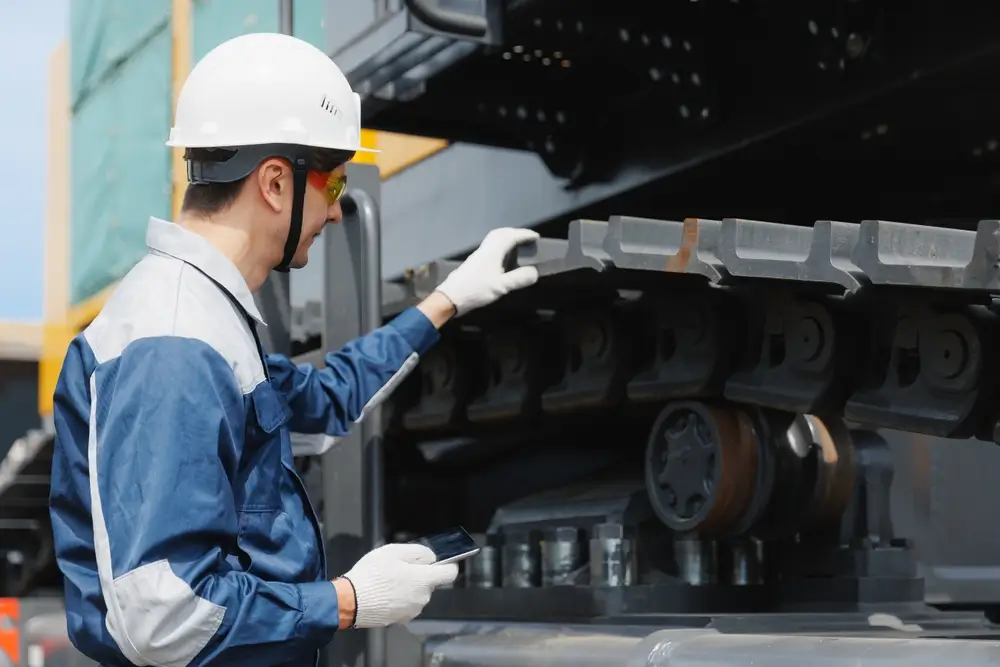 Young Caucasian male engineer inspecting machinery in mining industry.