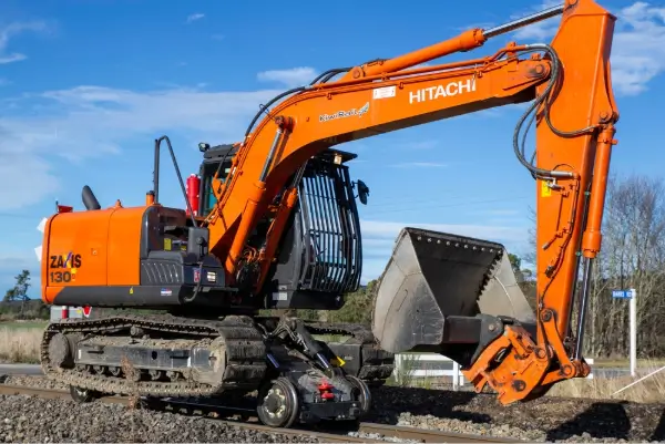 excavator or digger maintaining the train tracks on the main line to the West Coast.